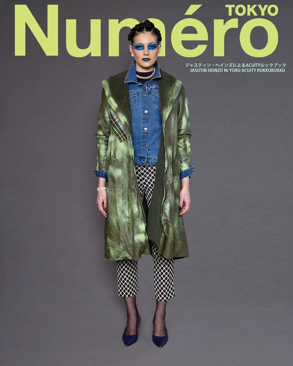 JUS10H by Justin Haynes ACUITY Collection lookbook for Numéro Tokyo by Scott Parker — model in olive green leather coat with tartan patch detail and signature embroidery, layered over classic denim jacket, paired with cream and navy lattice-print cro