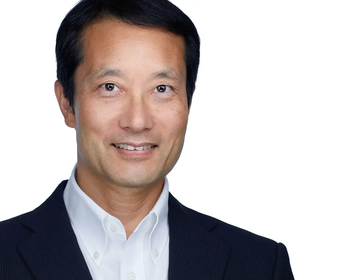 Physician headshot, navy pinstripe blazer and white shirt, warm approachable expression, white background, Connecticut, photographed by Scott Parker Photo