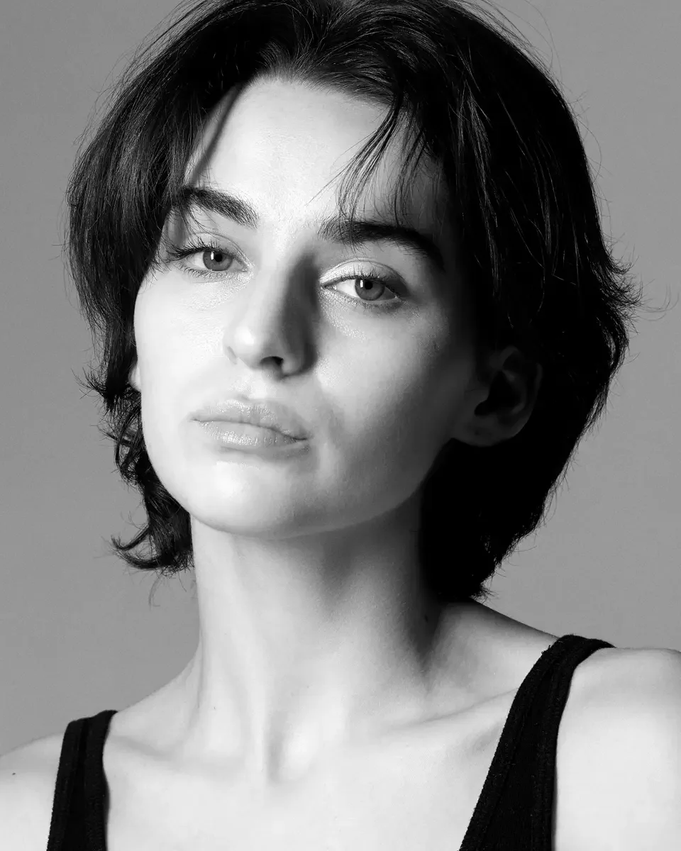 Tess, slight head turn, relaxed expression, black tank top, white background, black and white, New York studio test shoot, makeup by Schanica, photographed by Scott Parker Photo