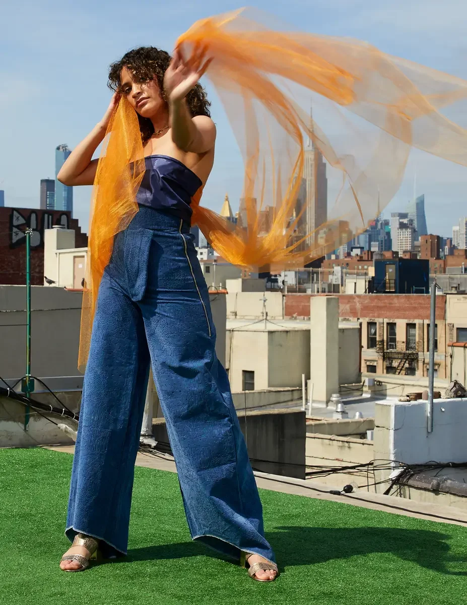 Fashion test shoot, model Ireland T in Amy Page DeBlasio wide-leg textured blue pants and navy strapless top with orange tulle, East Village rooftop, New York City, styling by Matsine Stinson, makeup by Stefani Paige Vivian, photographed by Scott Par