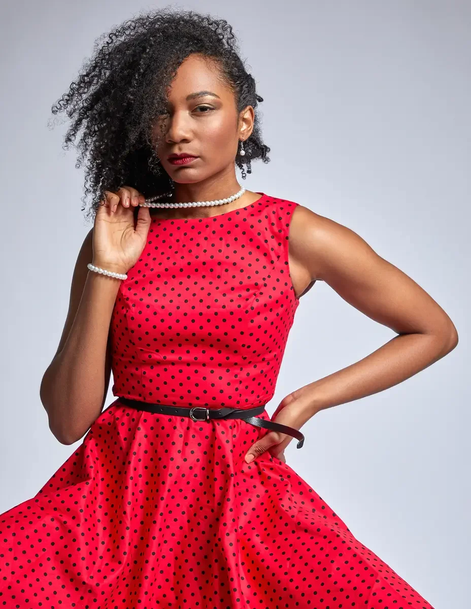 Arielle Chambers, standing, red polka dot dress, black faux fur coat open, pearl necklace, East Williamsburg studio test shoot, makeup by Schanica Pickens, photographed by Scott Parker Photo