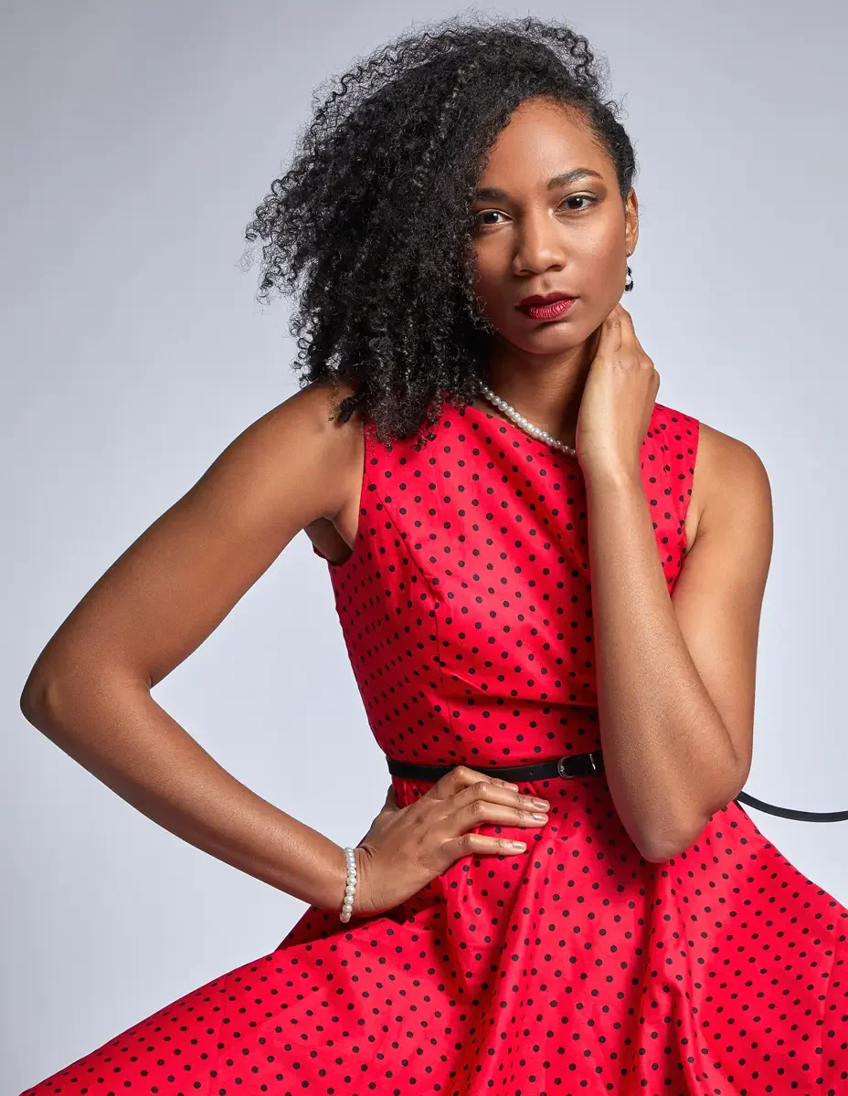 Arielle Chambers, laughing, red polka dot dress, pearl necklace and bracelet, East Williamsburg studio test shoot, makeup by Schanica Pickens, photographed by Scott Parker Photo
