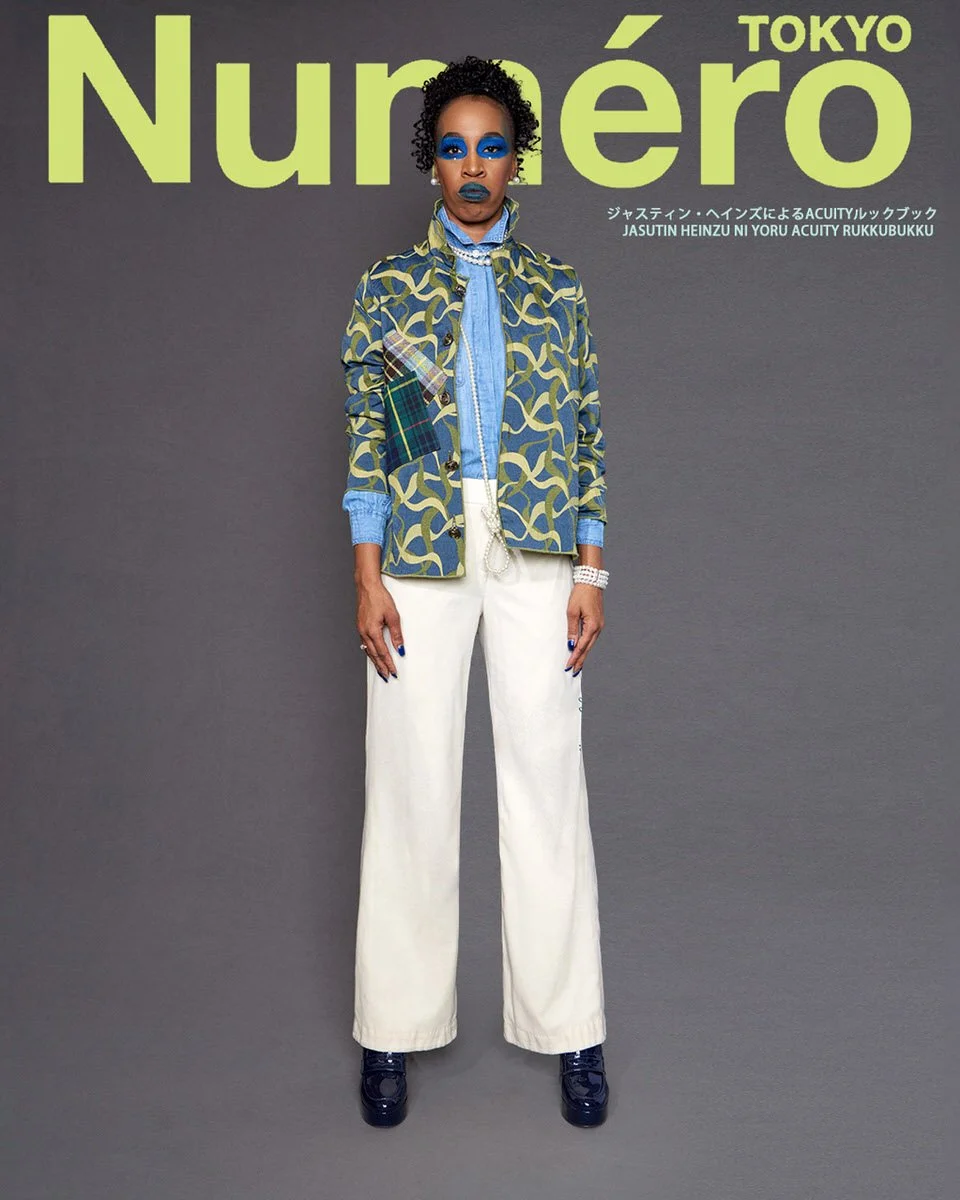 JUS10H by Justin Haynes ACUITY Collection lookbook for Numéro Tokyo by Scott Parker — model in chartreuse and navy ribbon-print quilted jacket with tartan patch pocket, layered over chambray button-down and pale blue knit, paired with cream wide-leg 