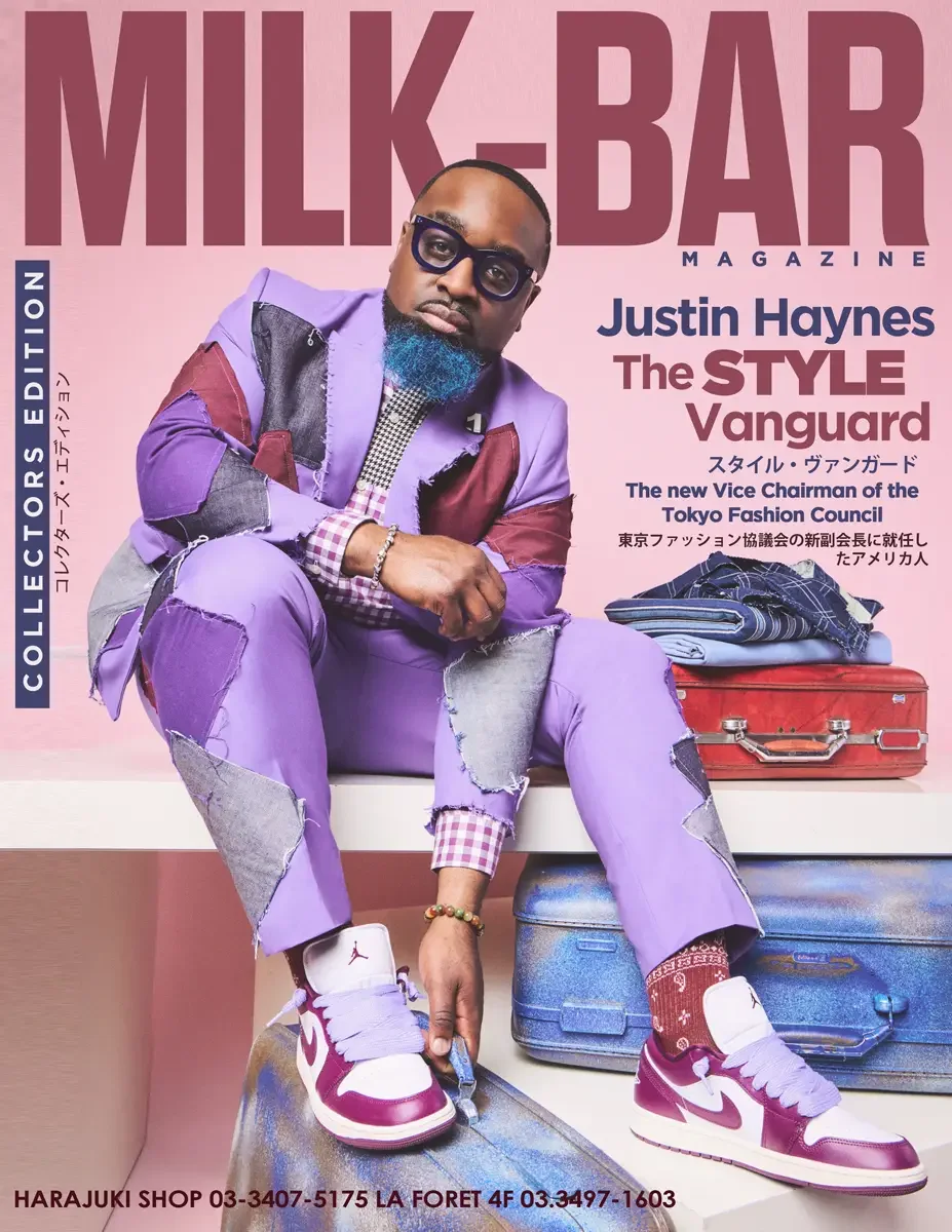JUS10H 2025 Milk Bar Magazine feature, Collectors Edition cover, Style Vanguard, lavender patchwork suit seated on vintage luggage, Tokyo Fashion Council Vice Chairman, photographed by Scott Parker Photo