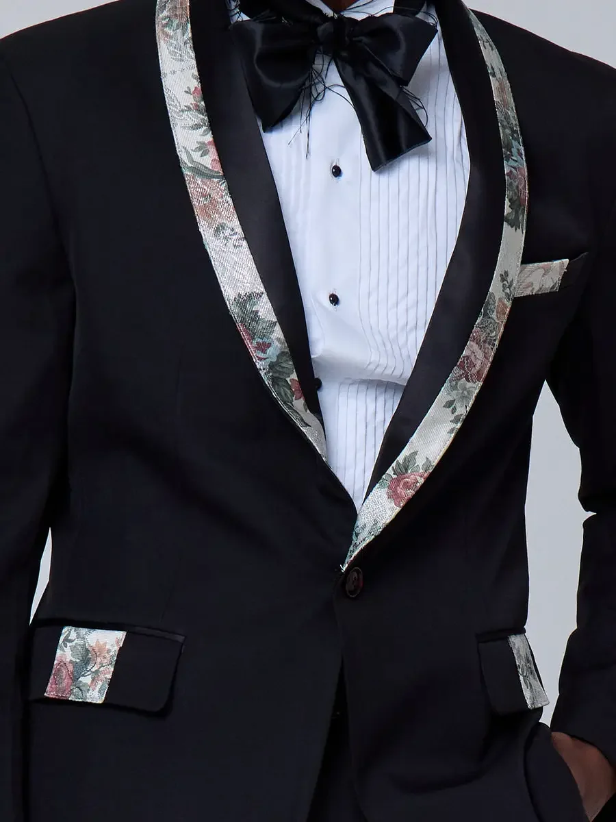 JUS10H 2025 New York Bridal Fashion Week, close detail of black single-button tuxedo with floral tapestry shawl lapels, matching pocket trim and pocket square, and black satin bow tie with pleated white dress shirt, photographed by Scott Parker Photo