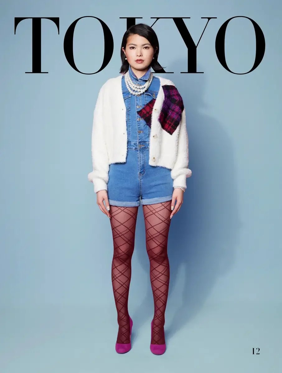 JUS10H 2025 Tokyo lookbook, white fluffy cardigan with pink and purple tartan patch over denim romper and diamond fishnet tights with fuchsia heels, light blue background, photographed by Scott Parker Photo for the Tokyo Fashion Council