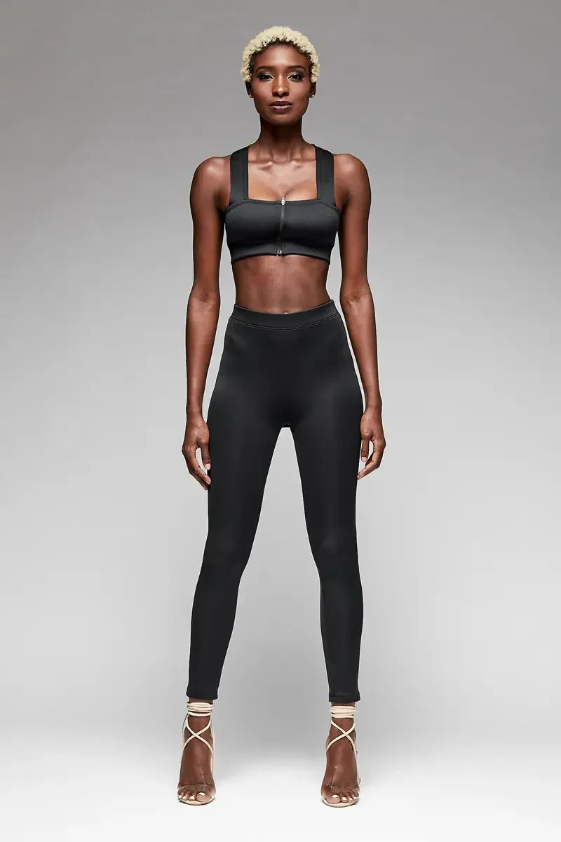 Minika Ko lookbook, black zip-front crop top and high-waist legging set, square neckline, center front zip closure, smooth synthetic fabric, lace-up heeled sandals, photographed by Scott Parker Photo