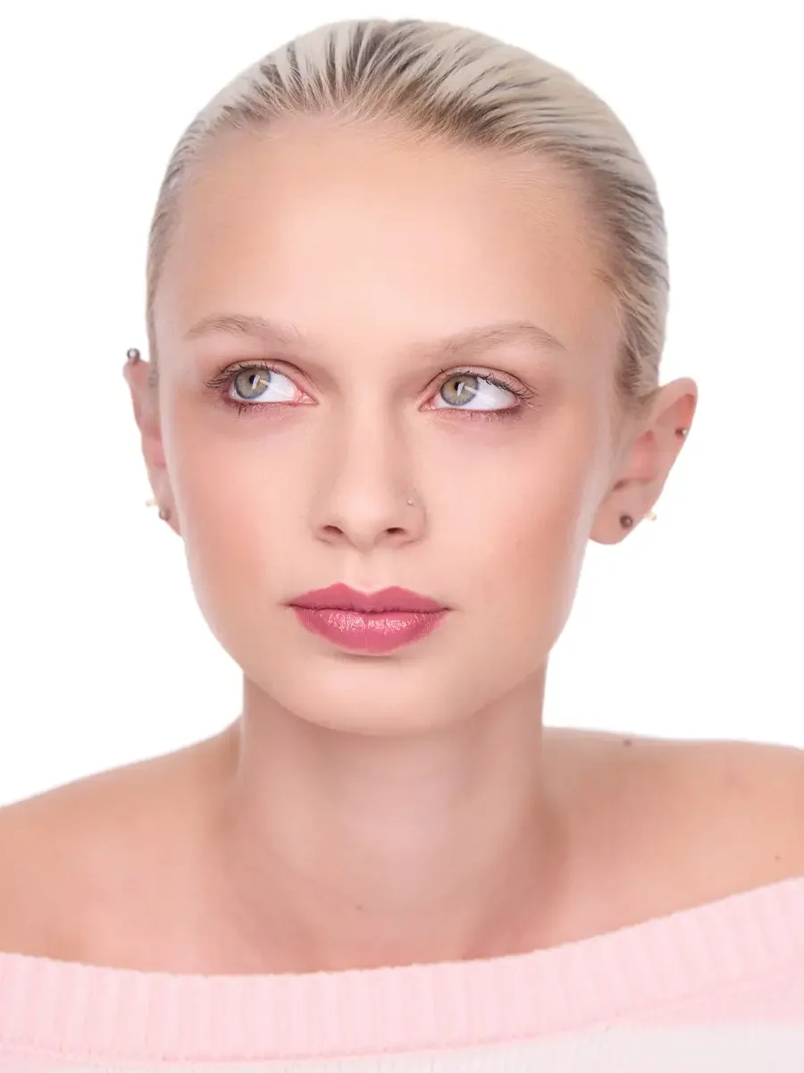 Model portfolio development session, beauty, close-crop, hair slicked back, face forward, gaze directed upward, rose lip, soft eye, pink off-shoulder sweater, white background, photographed by Scott Parker Photo, New York