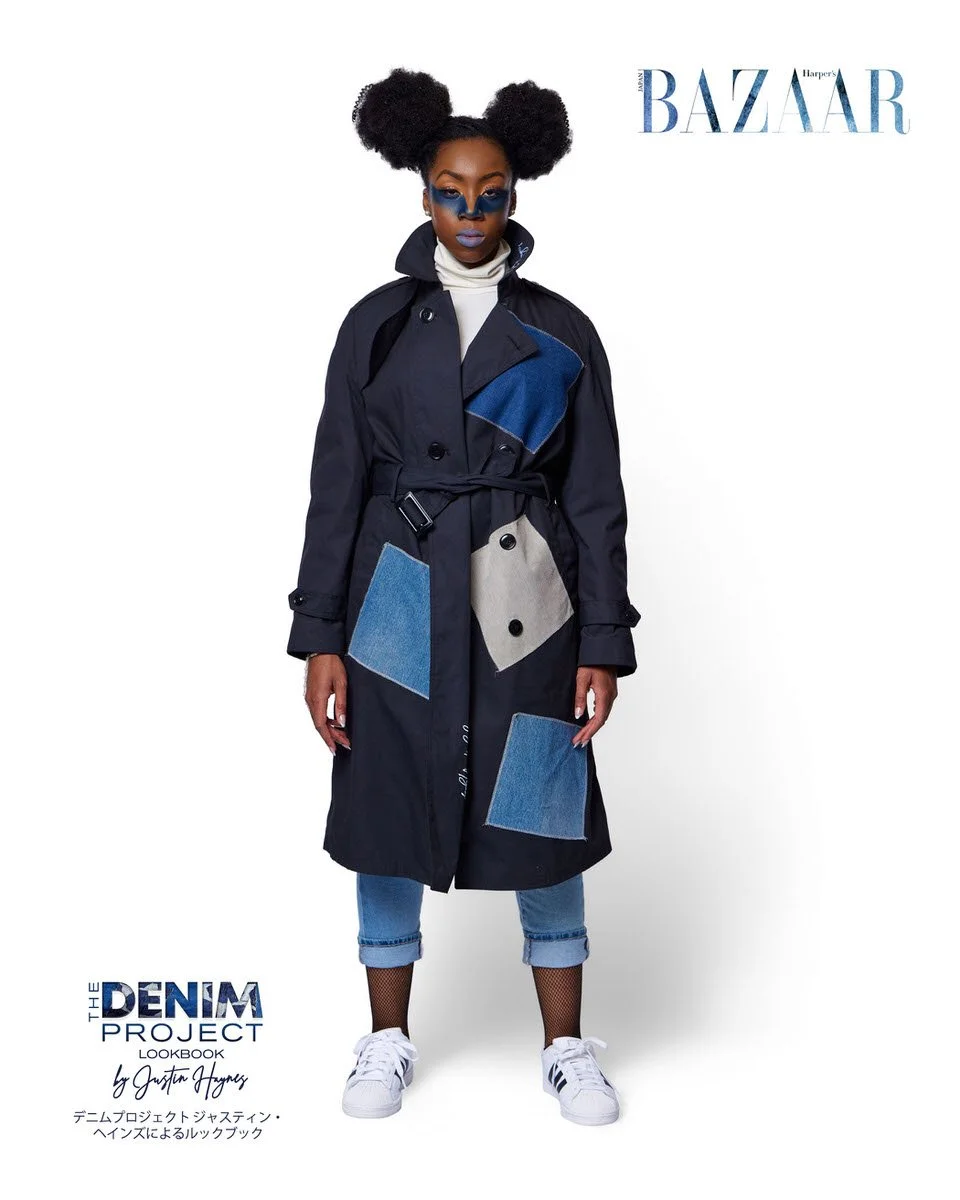 JUS10H Denim Project 2025 Harper's Bazaar Japan lookbook — model in belted navy trench coat with large geometric denim patchwork panels in medium blue and grey, worn over cuffed light-wash jeans with fishnet socks and Adidas Superstar sneakers, blue 