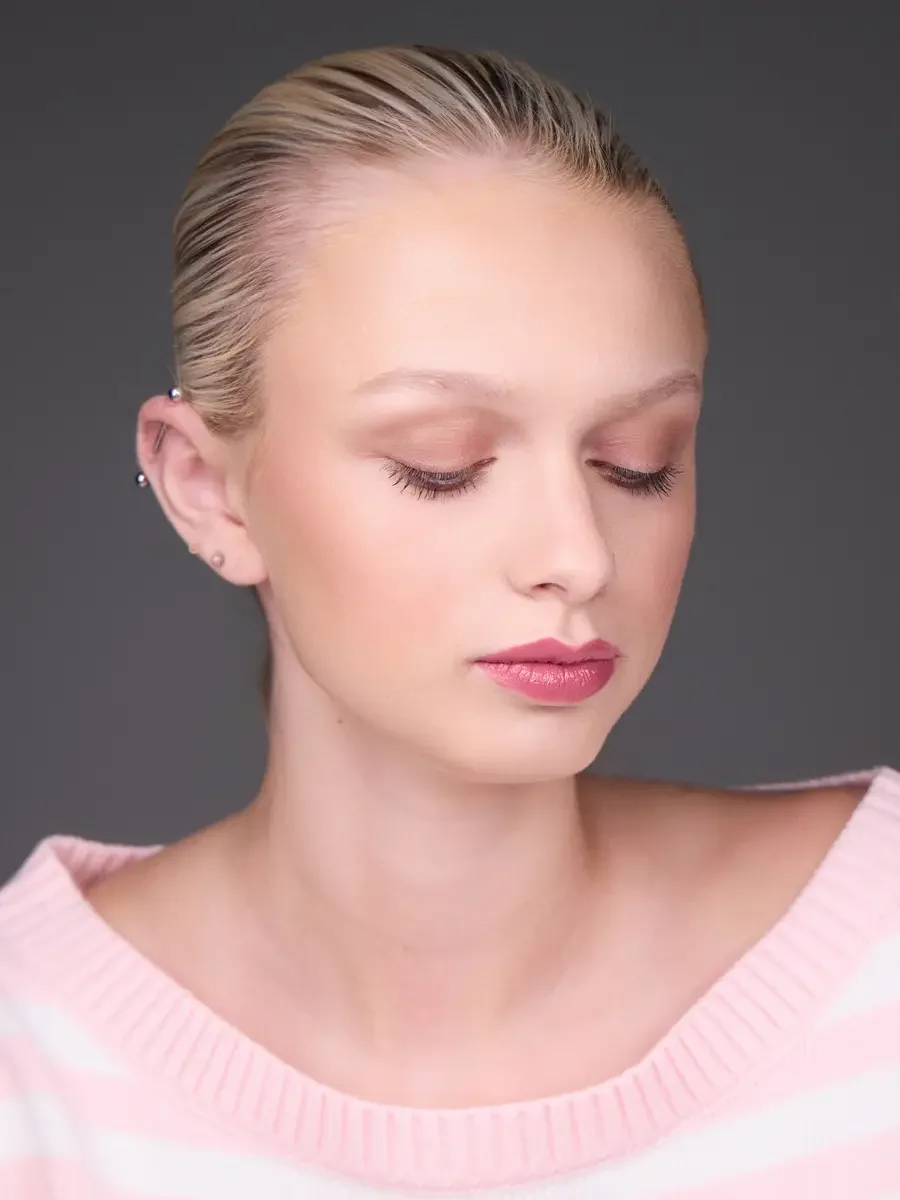 Model portfolio development session, beauty, close-crop, hair slicked back, slight turn, eyes closed, rose lip, soft eye, pink striped sweater, gray background, photographed by Scott Parker Photo, New York