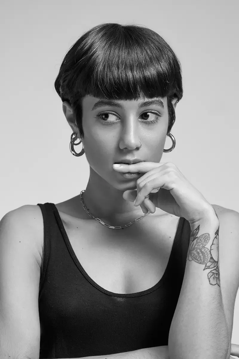 Eloissa, black and white portrait, gold hoop earrings and chain necklace, floral forearm tattoo, East Williamsburg studio test shoot, makeup by Schanica Pickens, photographed by Scott Parker Photo