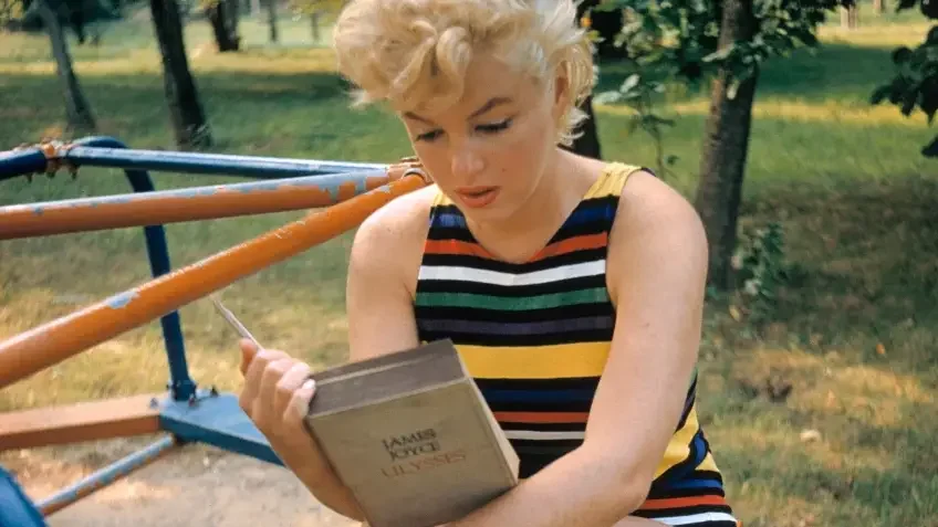 blonde woman sitting on playground in park reading james joyce marilyn monroe 1955 by eve arnold