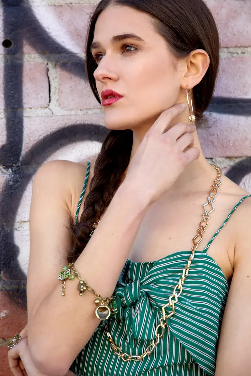 Victoria Henley, gold hoop earring and layered bracelet detail, green striped jumpsuit, graffiti wall, Los Angeles fashion week test shoot, photographed by Scott Parker Photo