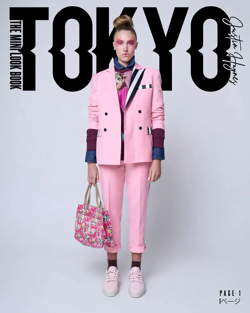 A woman in a pink suit with rolled-up pants, pink sneakers, and dark socks holding a floral tote bag. The light gray fashion background has text that reads "Tokyo" and "Lookbook" by Justin Haynes, photographed by Scott Parker Photo.