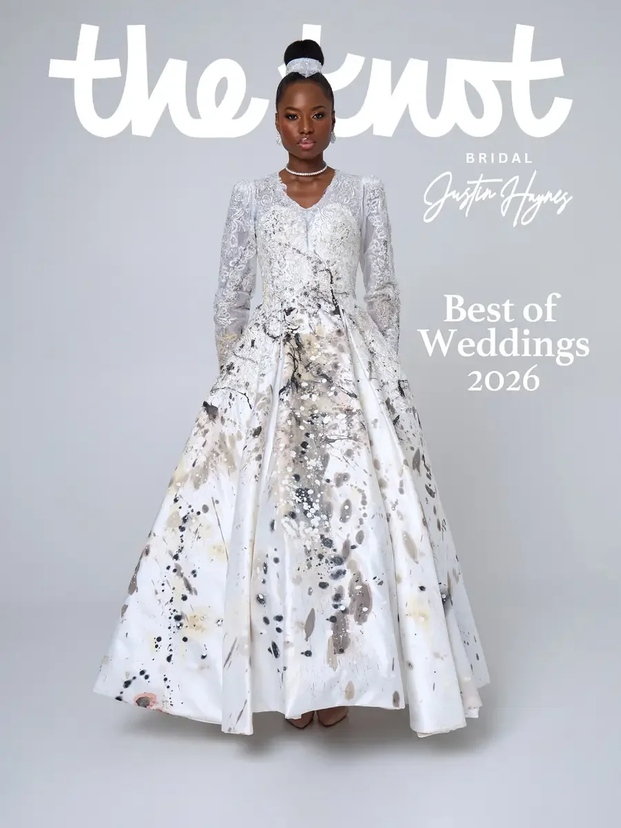 `JUS10H 2025 The Knot Bridal feature, Justin Haynes Best of Weddings 2026 cover, ivory abstract paint-splatter ball gown with long-sleeve lace bodice, structured shoulders, and pearl choker, photographed by Scott Parker Photo