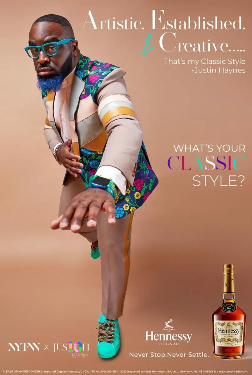 JUS10H 2022 Hennessy cross-promotional campaign, New York Fashion Week, full-length editorial in floral and colorblock patchwork suit, dynamic reaching pose, warm background, photographed by Scott Parker Photo
