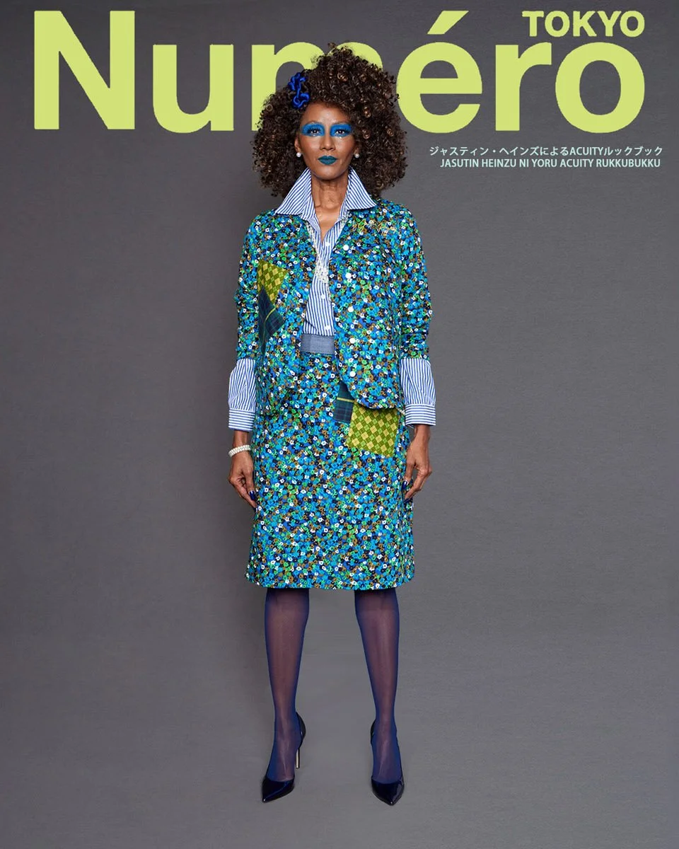 JUS10H by Justin Haynes ACUITY Collection lookbook for Numéro Tokyo by Scott Parker — model in matching teal floral-print jacket and skirt set with tartan and checkered patchwork detail, layered over blue and white striped button-down shirt, navy tig