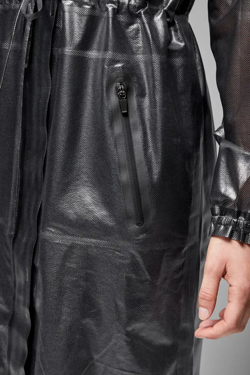 Minika Ko lookbook, detail, gunmetal metallic raincoat, close crop showing zip pocket at hip, drawstring waist, elasticated cuff, and high-gloss coated fabric surface texture, photographed by Scott Parker Photo