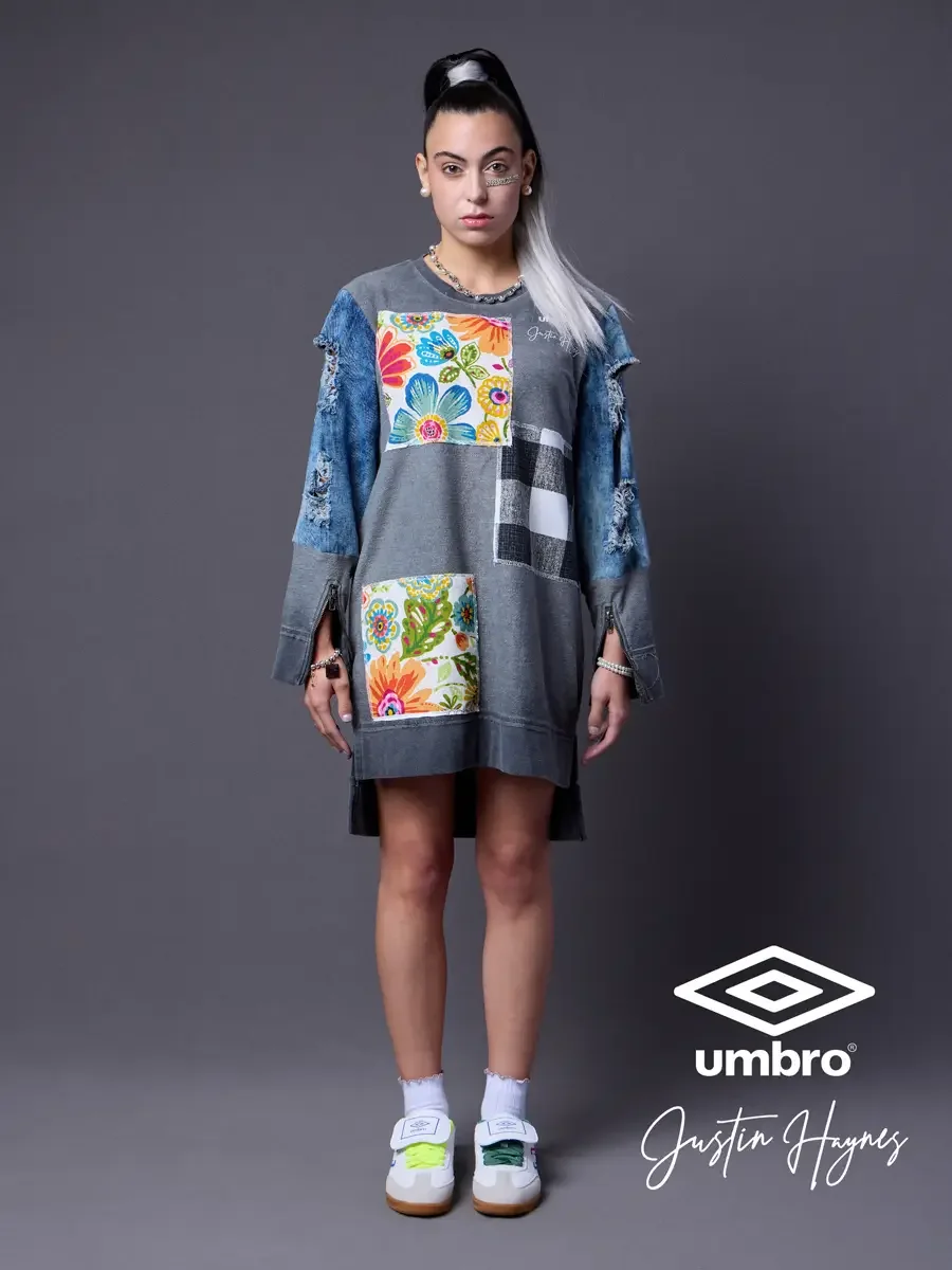 Lookbook photography for the Umbro France collection. Vanessa standing front-facing in an oversized acid-washed sweatshirt dress with floral patchwork panels and distressed denim sleeves, styled by Justin Haynes, photographed in Springfield, Massachu