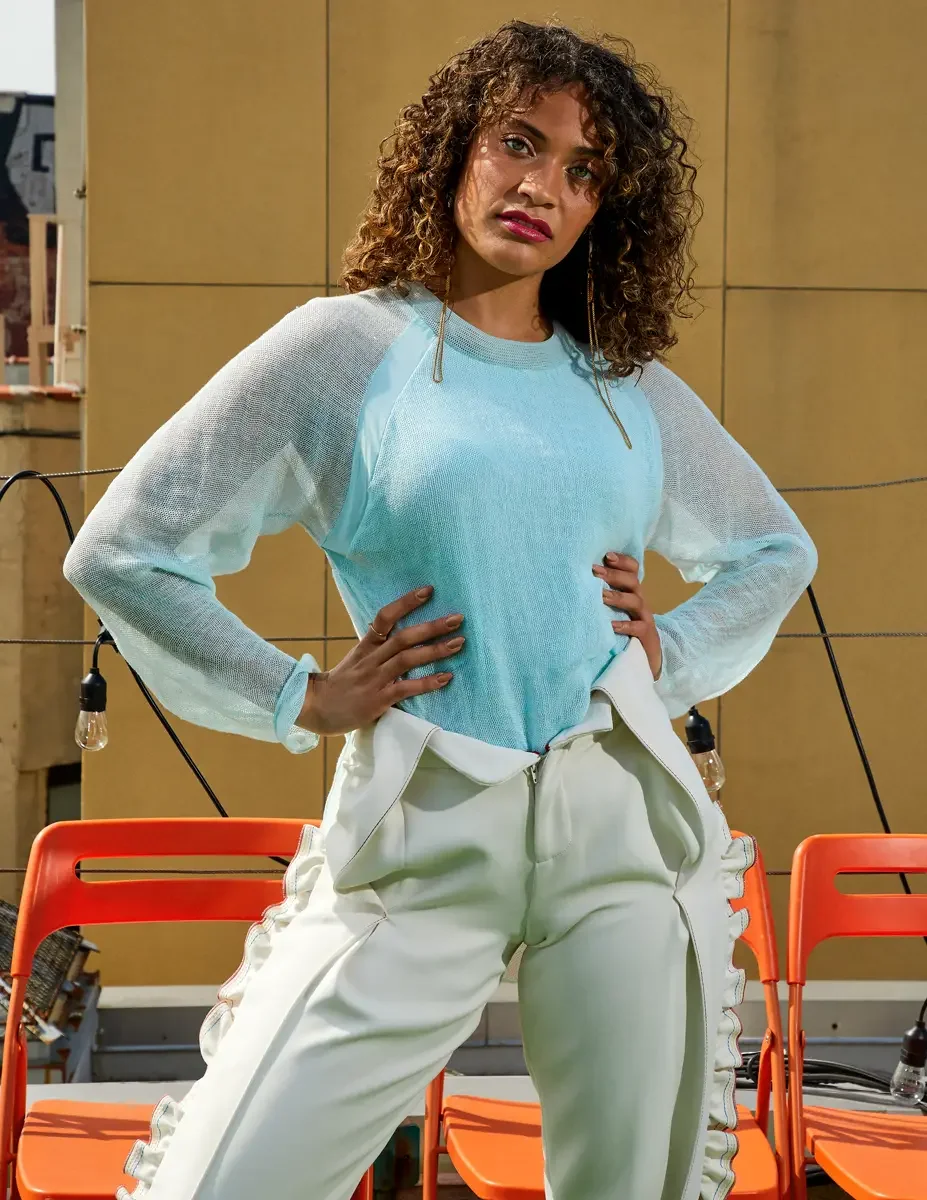 Fashion test shoot, model Ireland T in Amy Page DeBlasio white ruffle-trim pants and aqua sheer knit top, East Village rooftop, New York City, styling by Matsine Stinson, makeup by Stefani Paige Vivian, photographed by Scott Parker Photo