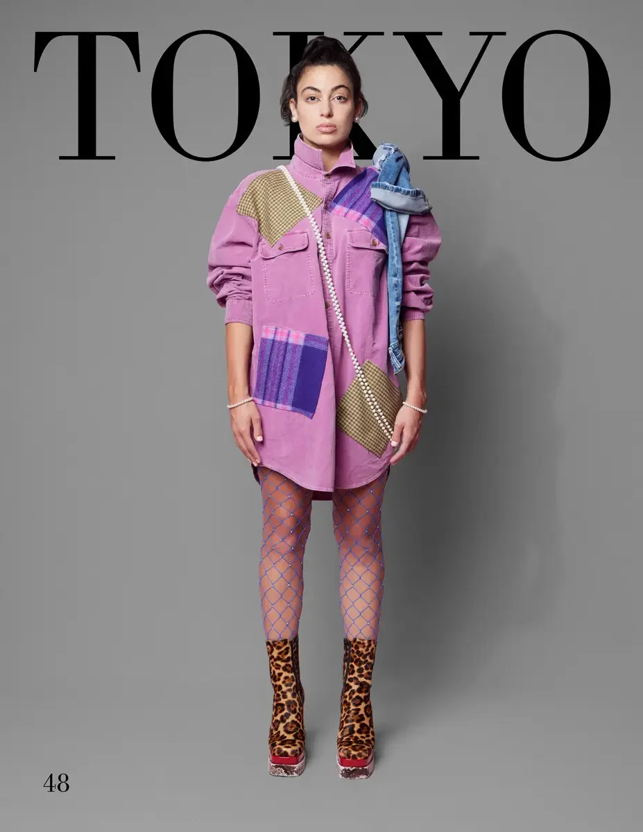 JUS10H 2025 Tokyo lookbook, a female model wearing an oversized mauve pink denim shirt dress with mixed tweed and plaid patchwork appliqués in olive, purple, and pink, styled with a pearl chain crossbody bag, pearl bracelets, pink diamond-pattern fis