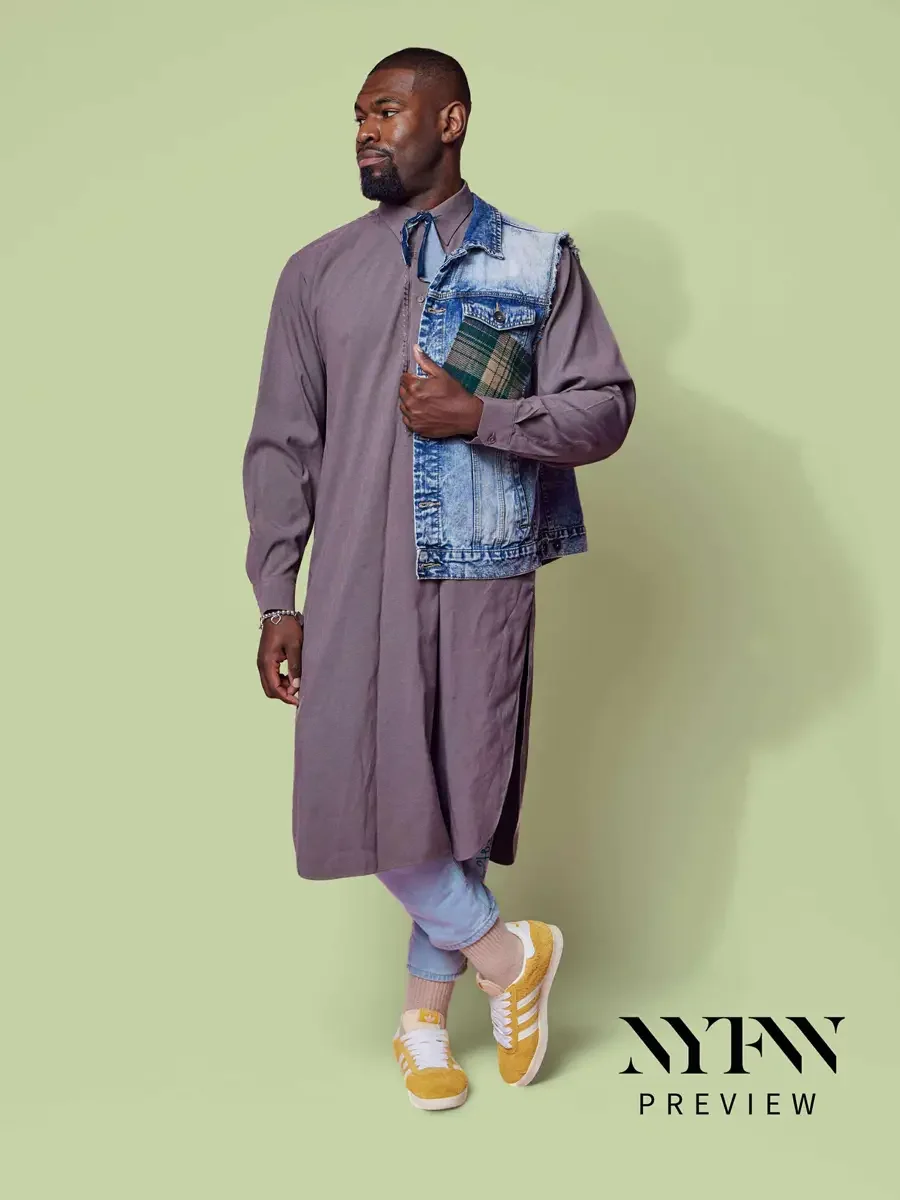 JUS10H 2025 billboard Times Square, model in mauve longline shirt-dress with patchwork denim vest over light blue trousers and yellow sneakers, sage green background, photographed by Scott Parker Photo