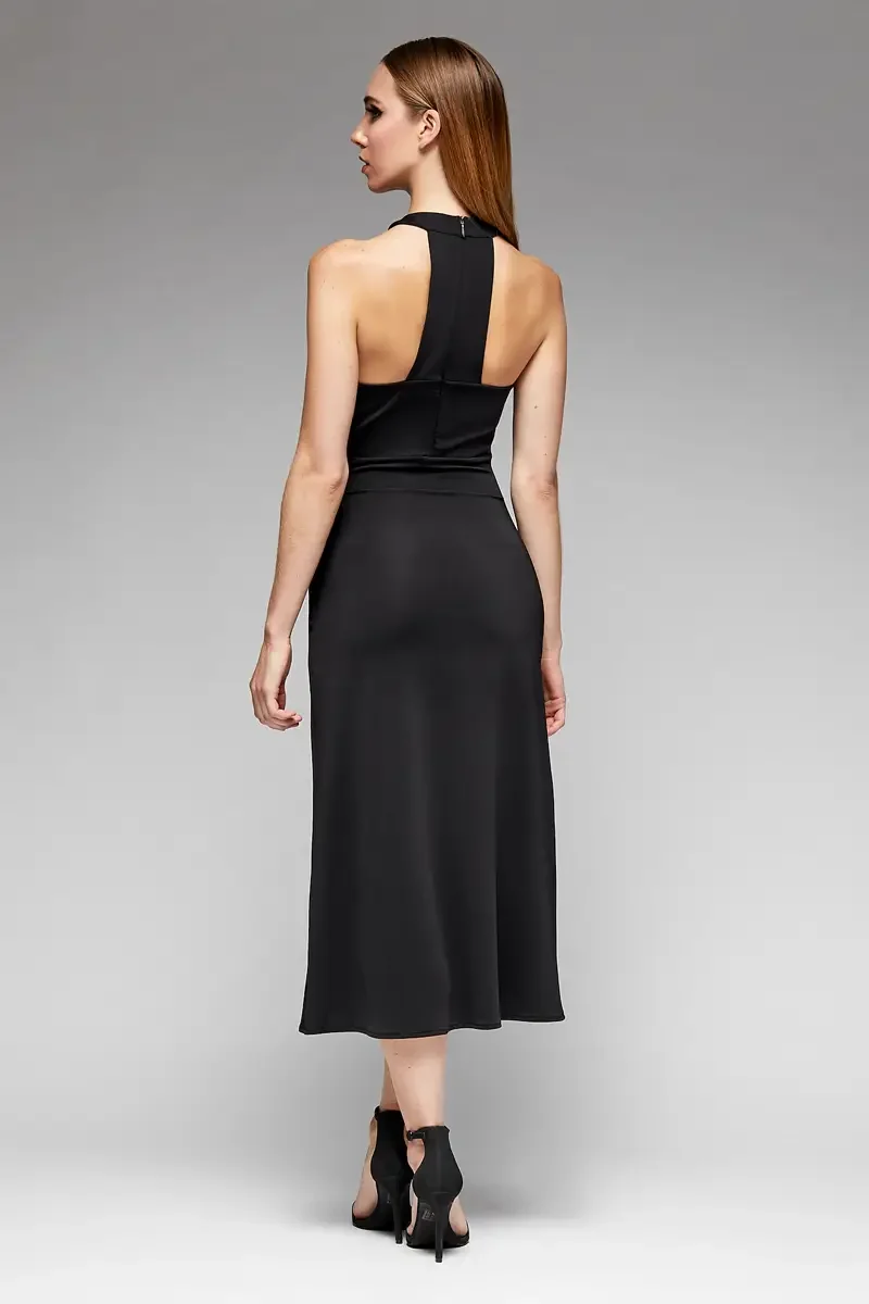 Minika Ko lookbook, black halter midi dress, back view, open racerback with center back zip, horizontal seam at waist, flared A-line skirt, smooth synthetic fabric, photographed by Scott Parker Photo