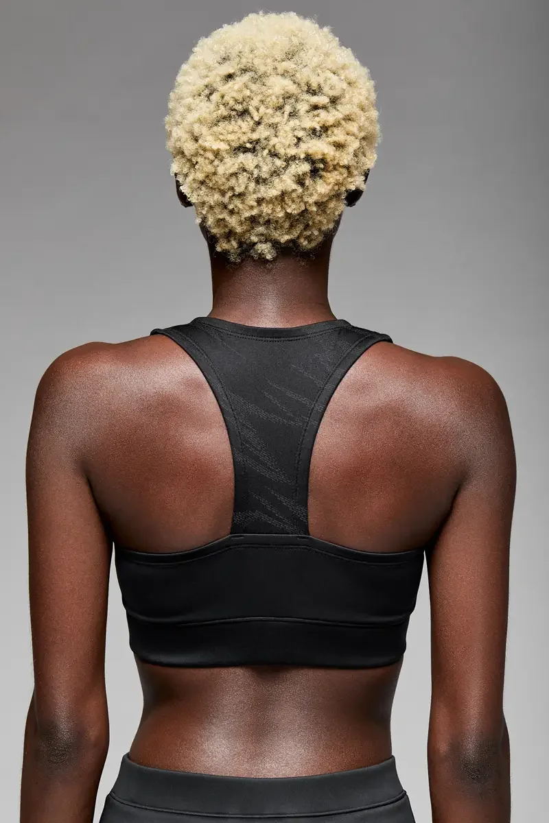 Minika Ko lookbook, black zip-front crop top, back view, racerback construction, smooth synthetic fabric, photographed by Scott Parker Photo