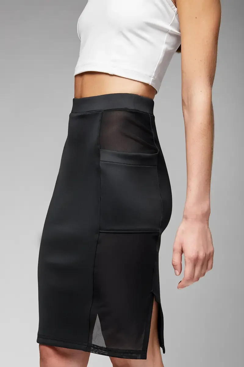 Minika Ko lookbook, detail, black high-waist midi skirt, side view showing sheer mesh pocket construction and center front vent at hem, photographed by Scott Parker Photo