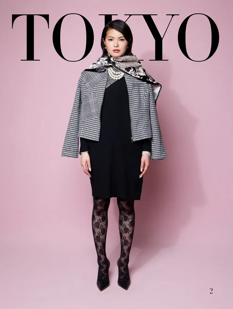 JUS10H 2025 Tokyo lookbook, houndstooth and glen plaid patchwork jacket over black dress with floral scarf and lace tights, pink background, photographed by Scott Parker Photo for the Tokyo Fashion Council