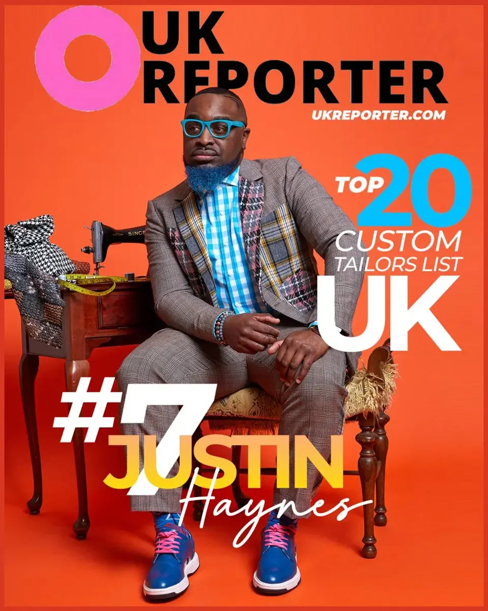JUS10H 2022 UK Reporter feature, Top 20 Custom Tailors ranked number seven, seated editorial portrait in patchwork grey suit with vintage sewing machine, orange background, photographed by Scott Parker Photo