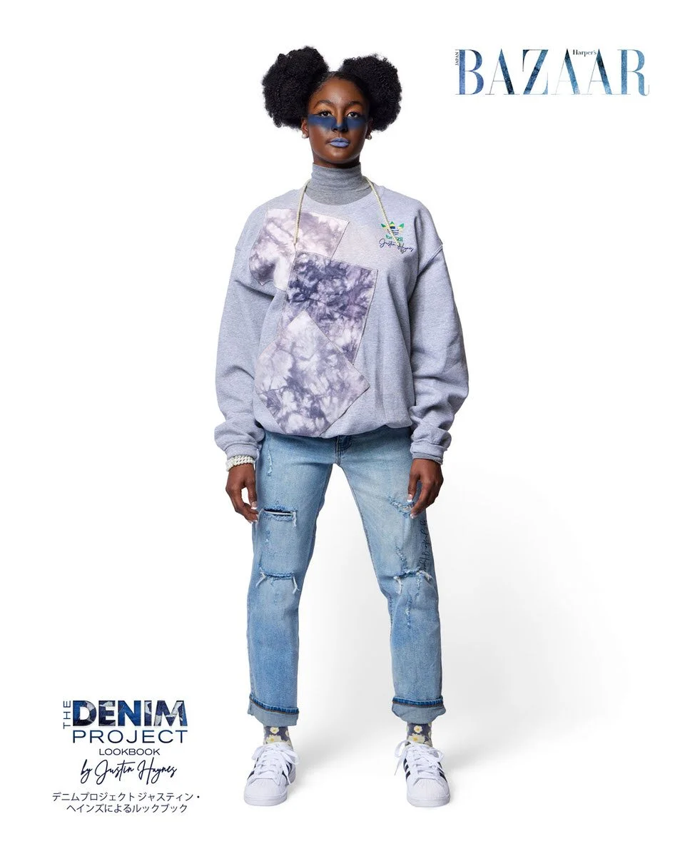 JUS10H Denim Project 2025 Harper's Bazaar Japan lookbook — model in oversized grey marl sweatshirt with large geometric purple tie-dye appliqué panels and Adidas Brazil x JUS10H emblem over light-wash distressed straight-leg jeans with floral print s