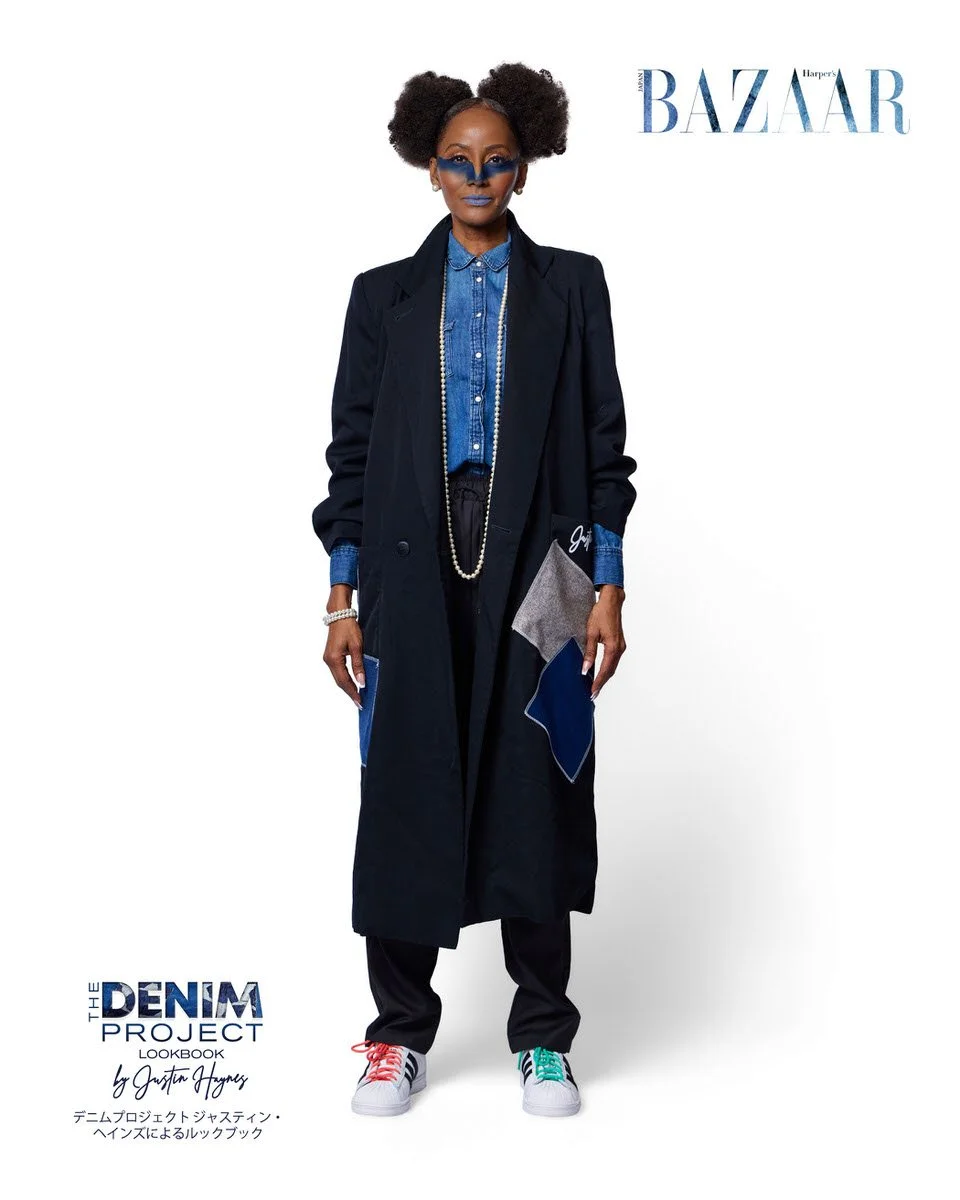 

JUS10H Denim Project 2025 Harper's Bazaar Japan lookbook — model in floor-length black blazer-coat with denim and grey geometric patchwork pocket detail over open-collar denim shirt, wide-leg black trousers, long pearl rope necklace, multicolor-lac