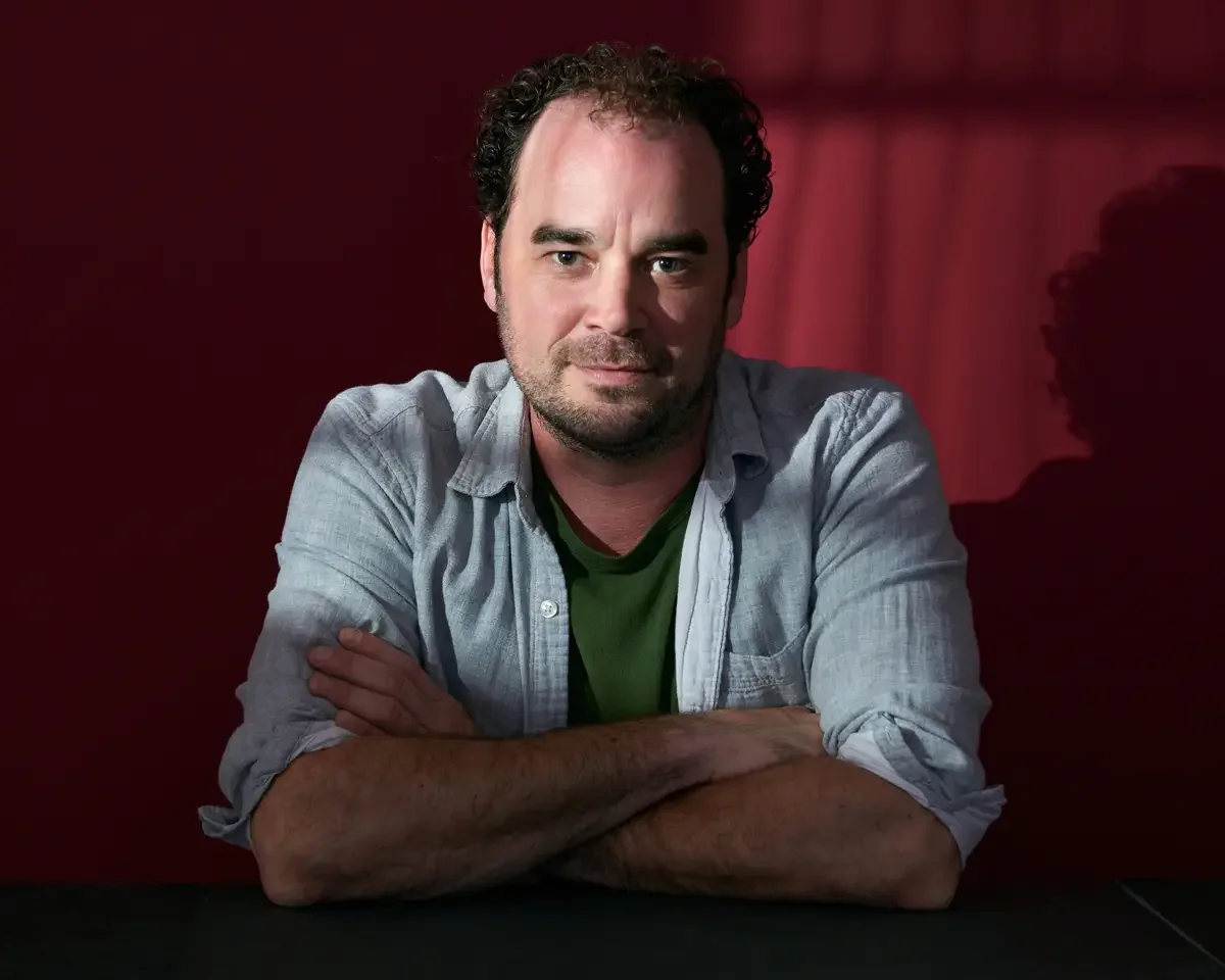 Nonprofit leader portrait, on-location environmental portrait, casual professional attire, deep red background, Connecticut, photographed by Scott Parker Photo