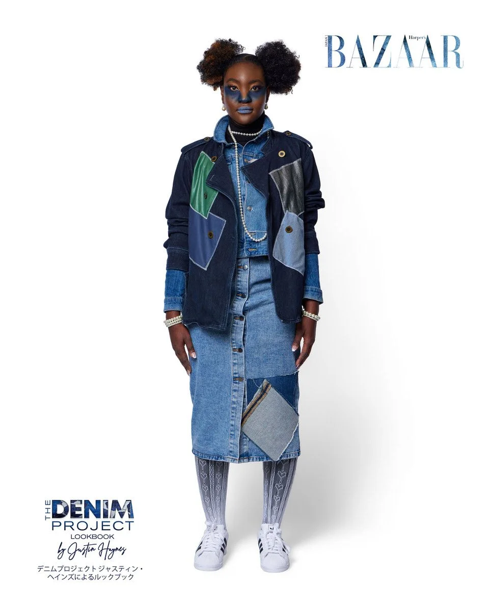 JUS10H Denim Project 2025 Harper's Bazaar Japan lookbook — model in triple-denim layered look featuring dark indigo patchwork military vest with green leather and charcoal panels over a light-wash button-front denim midi dress with grey flannel patch