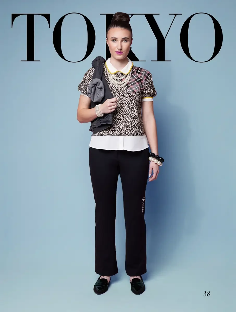 JUS10H 2025 Tokyo lookbook, a model wearing a mixed print short-sleeve top with a yellow-trimmed white Peter Pan collar and plaid panel, layered over a white button-down shirt, paired with black wide-leg trousers with script embroidery at the hem, pe