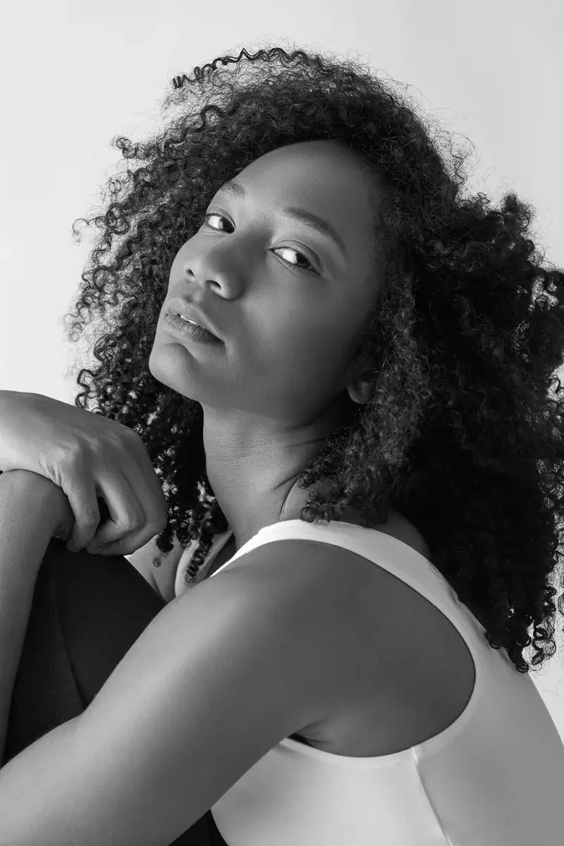 Arielle Chambers, black and white portrait, pleated fabric draped over shoulder, East Williamsburg studio test shoot, makeup by Schanica Pickens, photographed by Scott Parker Photo
