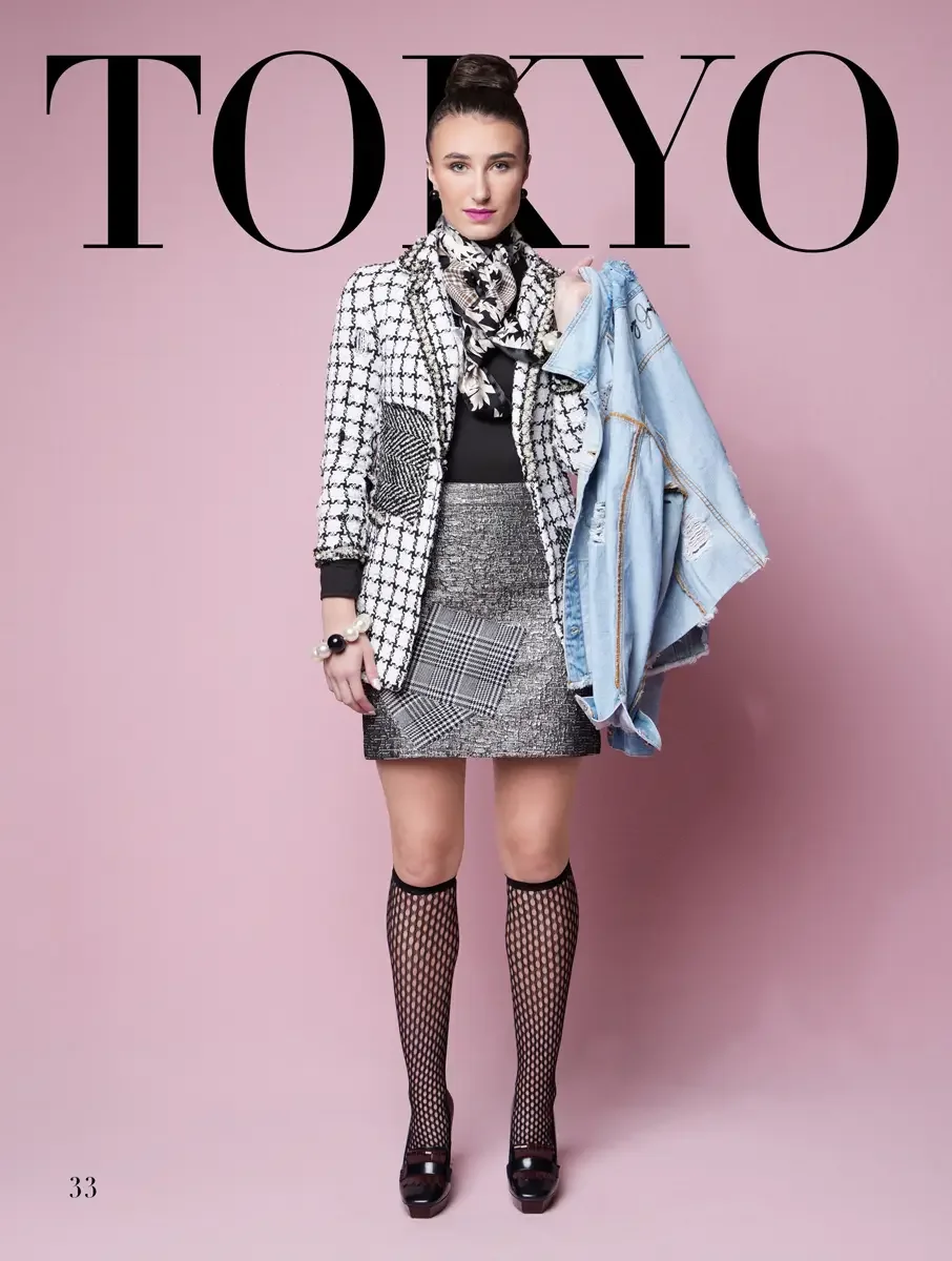 JUS10H 2025 Tokyo lookbook, a model wearing a black-and-white houndstooth tweed blazer with mixed patchwork panels, a patchwork metallic and plaid mini skirt, a black turtleneck, a floral silk scarf at the neck, pearl and black bead jewelry, black fi
