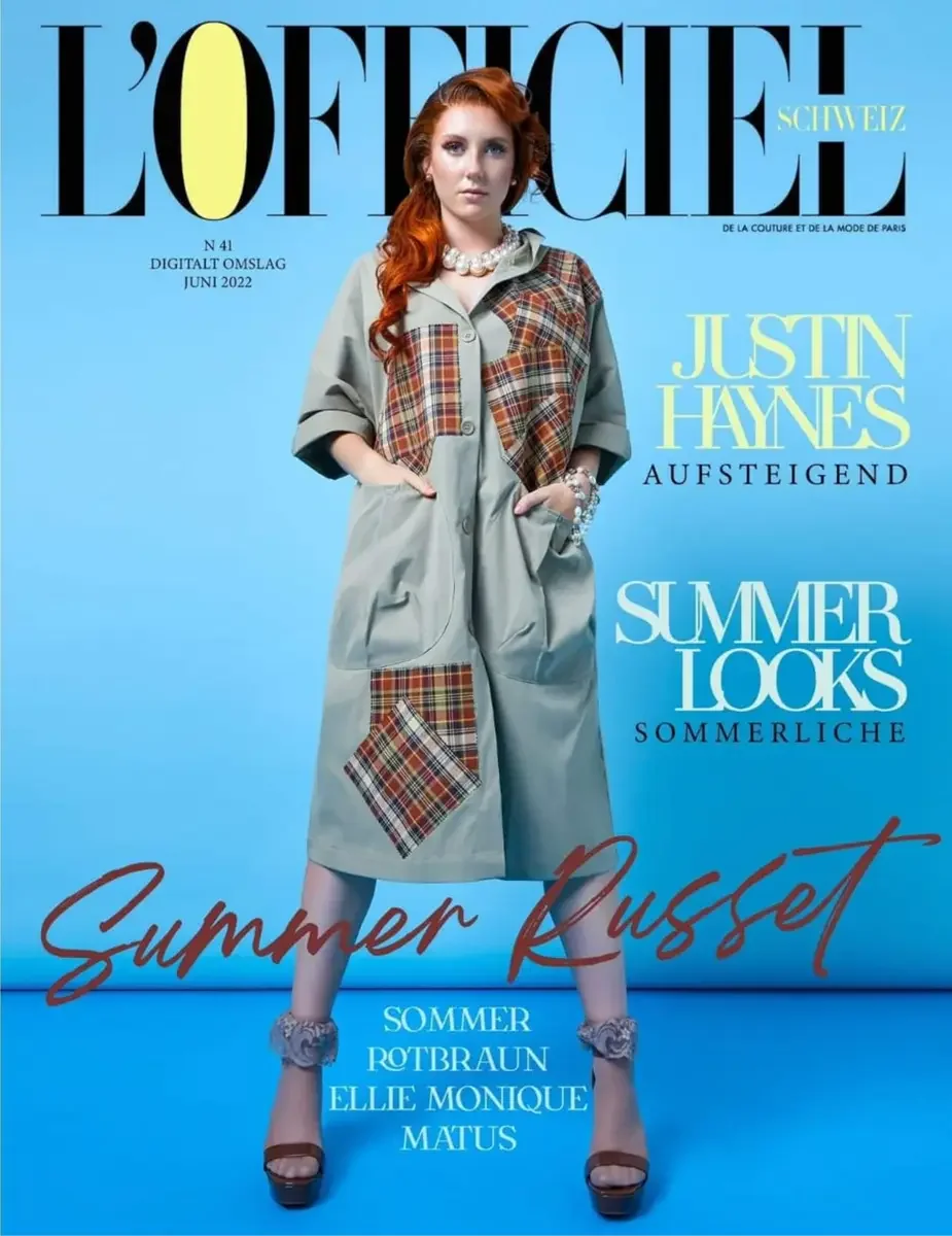 JUS10H 2022 L'Officiel Switzerland feature, editorial cover, sage green patchwork trench coat with tartan detail, pearl necklace, blue background, photographed by Scott Parker Photo