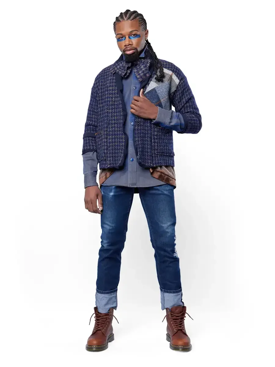 Men's fashion editorial photography, houndstooth jacket layered over denim shirt with indigo jeans and brown boots, white background, photographed by Scott Parker Photo