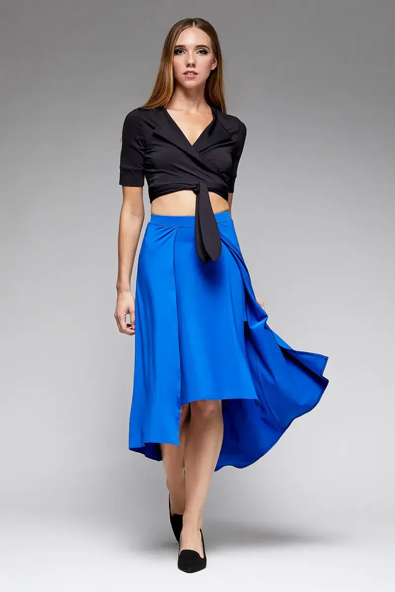 Minika Ko lookbook, cobalt blue asymmetric midi skirt and black wrap crop top, front view, high-low hem, pleated panel at hip, skirt in motion, black elbow-length wrap top with tie at waist, photographed by Scott Parker Photo