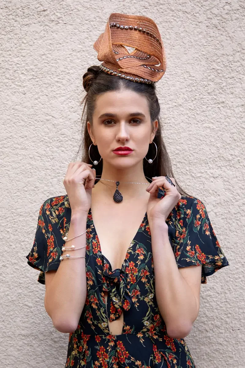 Victoria Henley, profile, copper woven sculptural fascinator, black floral maxi dress, stucco wall, Los Angeles fashion week test shoot, photographed by Scott Parker Photo