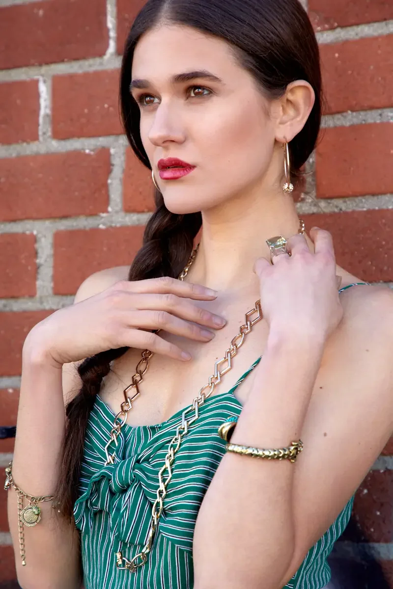  Victoria Henley, gold chain necklace and charm bracelet detail, green striped jumpsuit, graffiti wall, Los Angeles fashion week test shoot, photographed by Scott Parker Photo