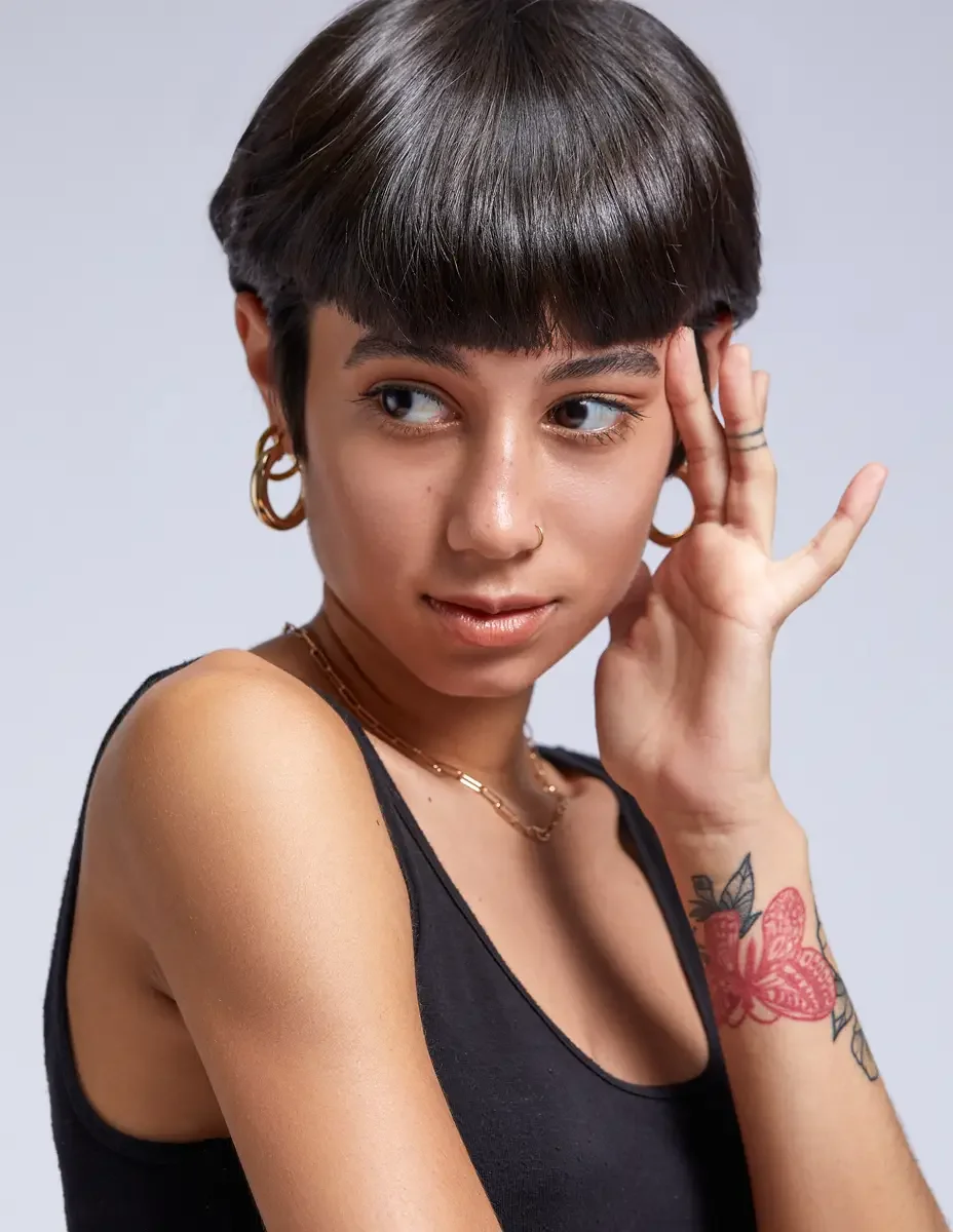 Eloissa, close portrait, gold hoop earrings, nose ring, layered chain necklace, floral wrist tattoo, East Williamsburg studio test shoot, makeup by Schanica Pickens, photographed by Scott Parker Photo