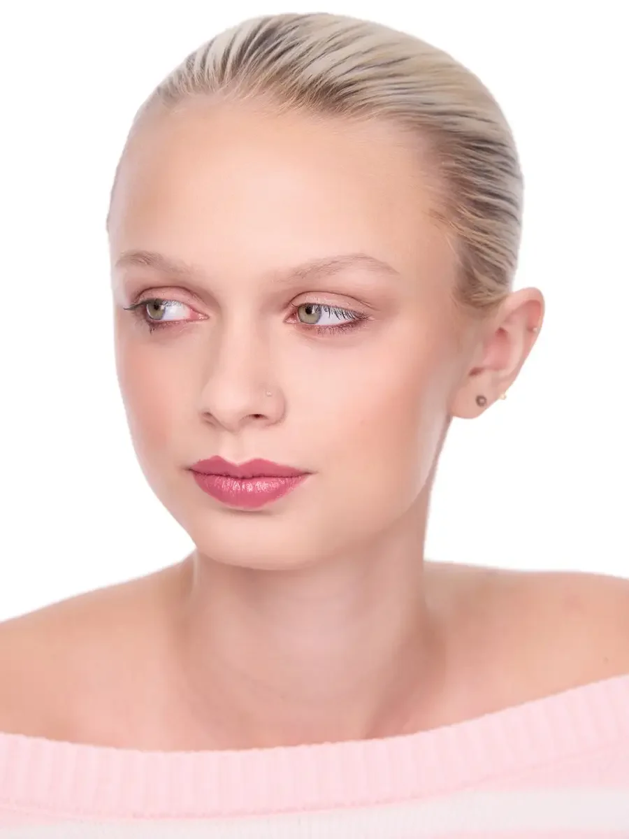 Model portfolio development session, beauty, close-crop, hair slicked back, slight turn, gaze directed right, rose lip, soft eye, pink off-shoulder sweater, white background, photographed by Scott Parker Photo, New York