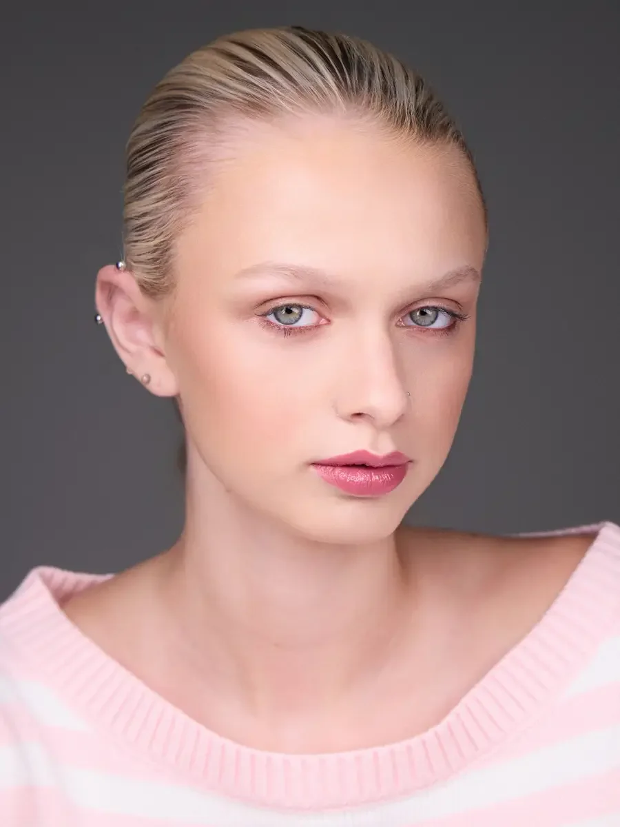 Model portfolio development session, beauty, close-crop, hair slicked back, slight turn, direct gaze, rose lip, soft eye, pink striped sweater, gray background, photographed by Scott Parker Photo, New York