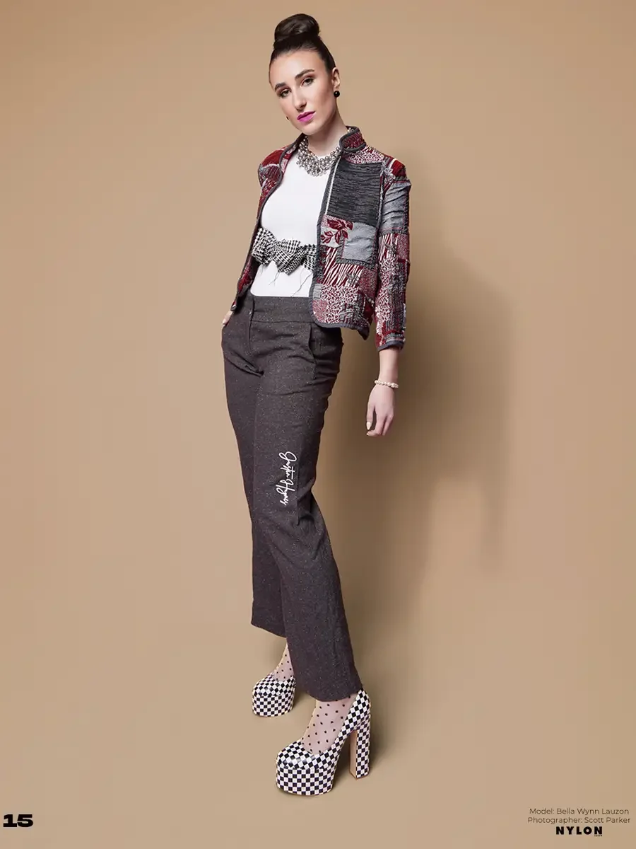 JUS10H 2025 Nylon Japan feature, model in multicolor patchwork cropped jacket with houndstooth bow detail over white tee and charcoal wide-leg trousers with JUS10H script detail, crystal statement necklace, black and white checkerboard platform heels
