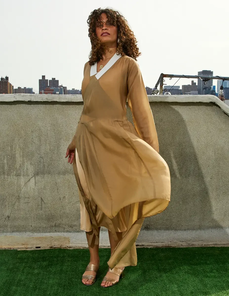 Fashion test shoot, full-length, model Ireland T in a gold satin wrap dress with white collar detail, Manhattan skyline, East Village rooftop, New York City, styling by Matsine Stinson, makeup by Stefani Paige Vivian, photographed by Scott Parker Pho
