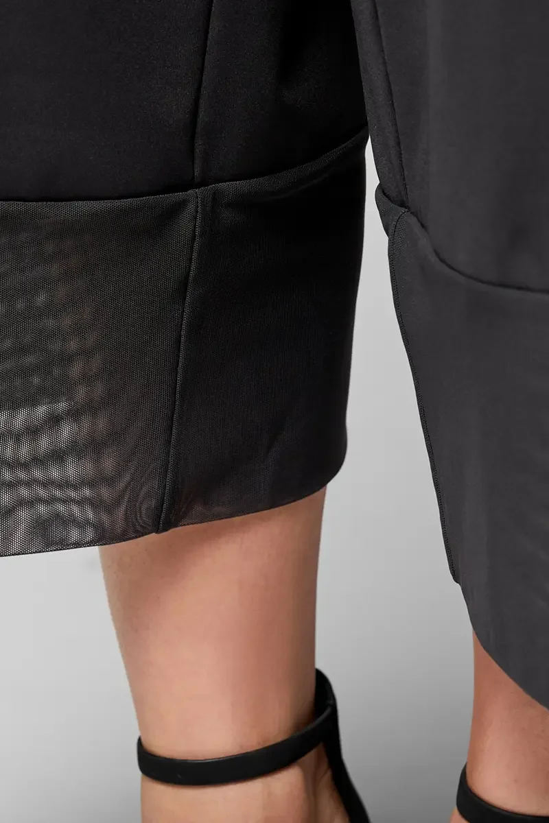 Minika Ko lookbook, detail, black wide-leg culottes, close crop of sheer mesh cuff at hem showing fabric transition from smooth synthetic to mesh panel, photographed by Scott Parker Photo