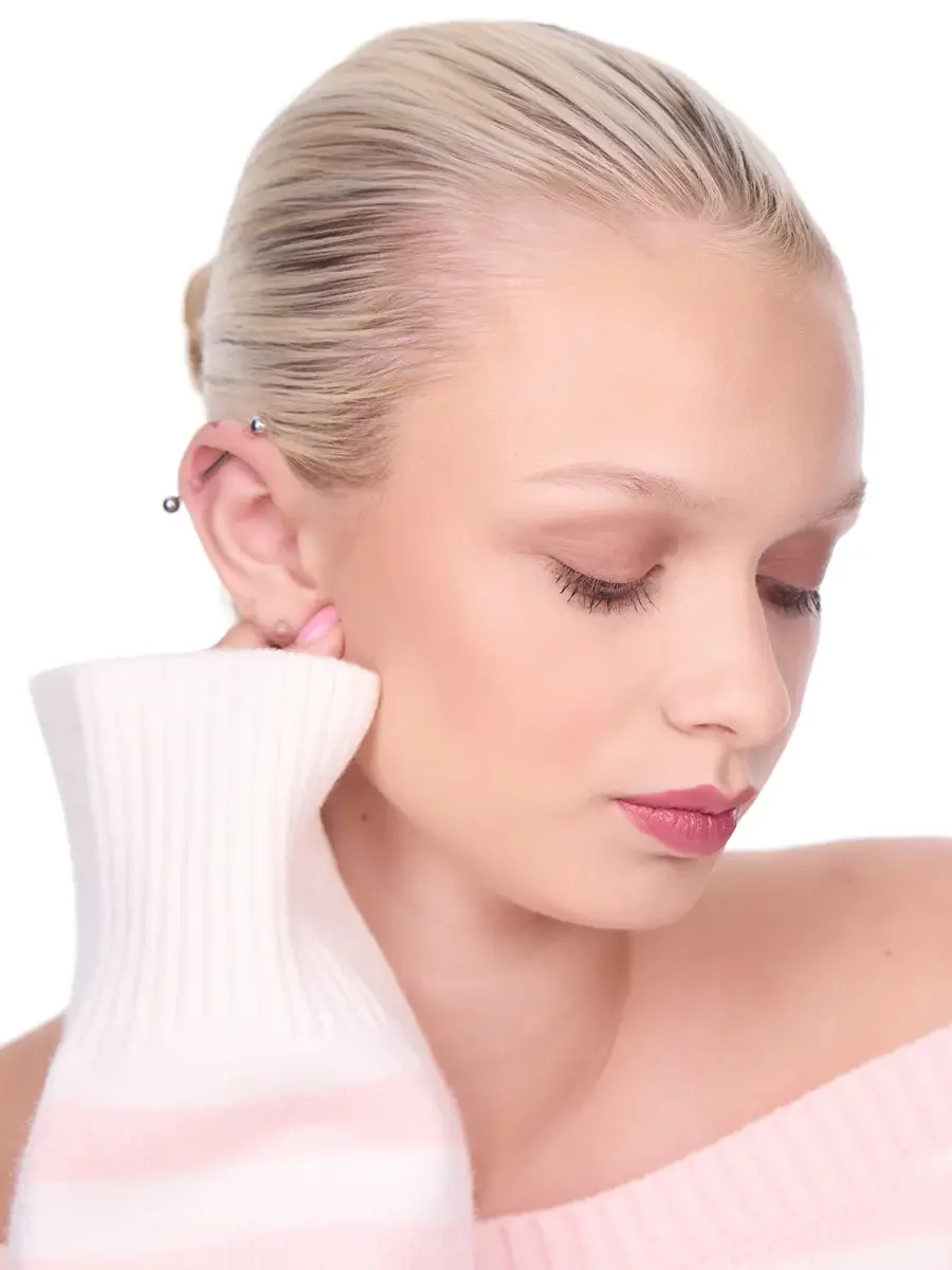 Model portfolio development session, beauty, close-crop, hair slicked back, profile turn, eyes closed, rose lip, soft eye, pink ribbed sweater held against ear, white background, photographed by Scott Parker Photo, New York